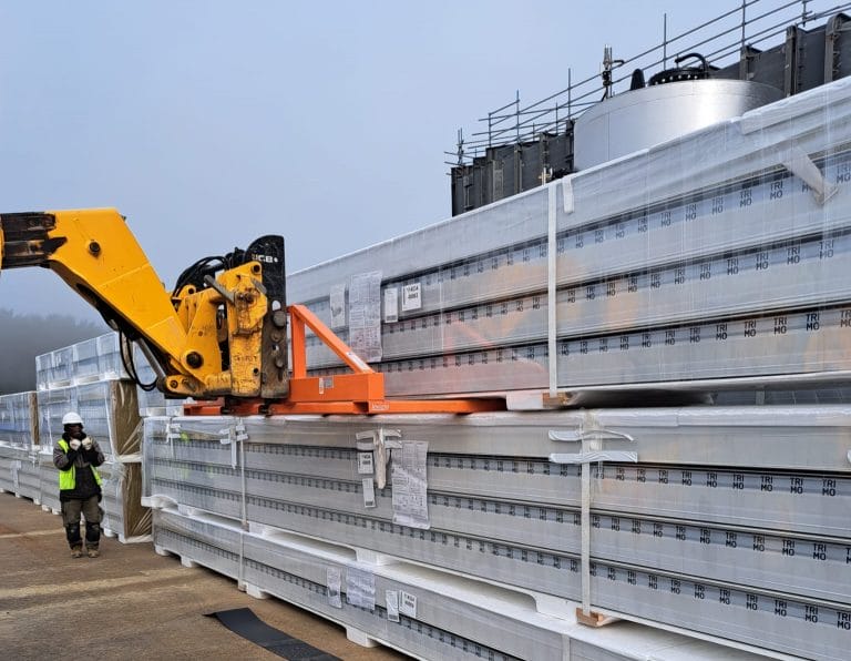 Four Fork Attachment unloading cladding panels from a delivery vehicle